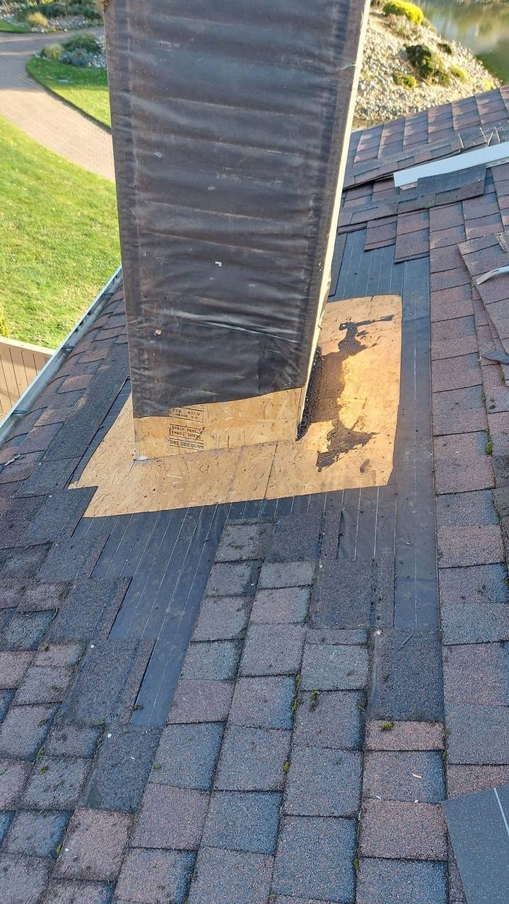 Chimney flashing replacement in progress on Chilliwack asphalt roof - Fraser Roofing Fraser Valley