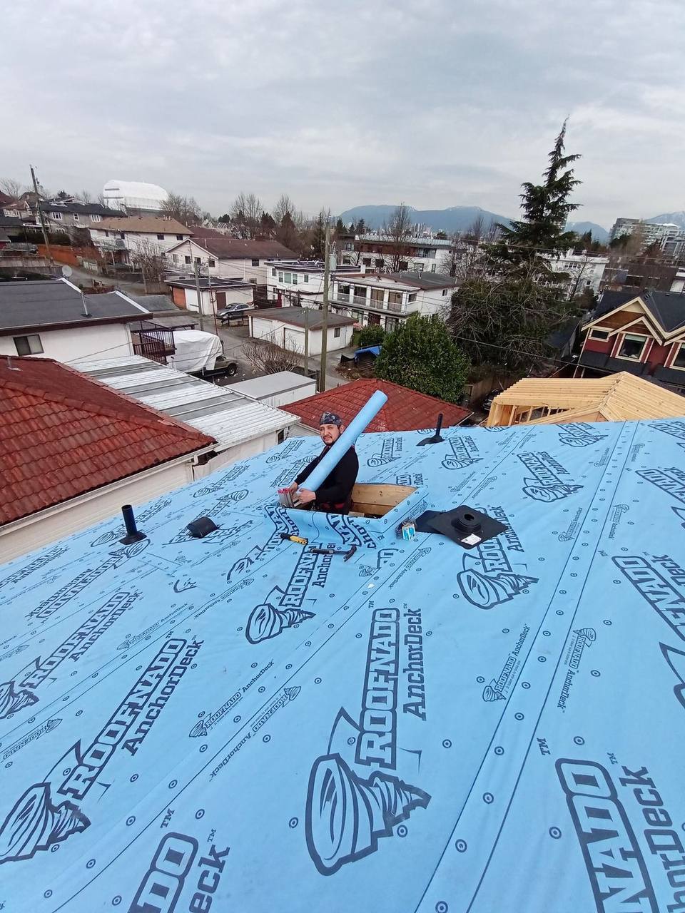 Johnny Peters, Owner, Estimator and Sales at Fraser Roofing, installing Roofnado AnchorDeck synthetic underlayment on a residential roof in the Fraser Valley, BC