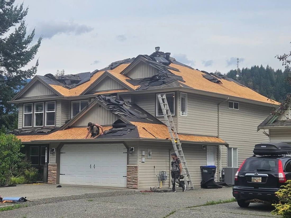 Large residential roof tear-off job in Chilliwack with all old shingles removed exposing bare decking, ready for new installation by Fraser Roofing
