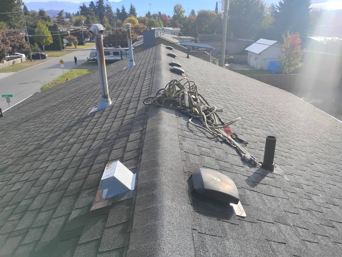 Fraser Roofing crew starting a roofing job in the Fraser Valley with materials staged and tear-off in progress on a residential home