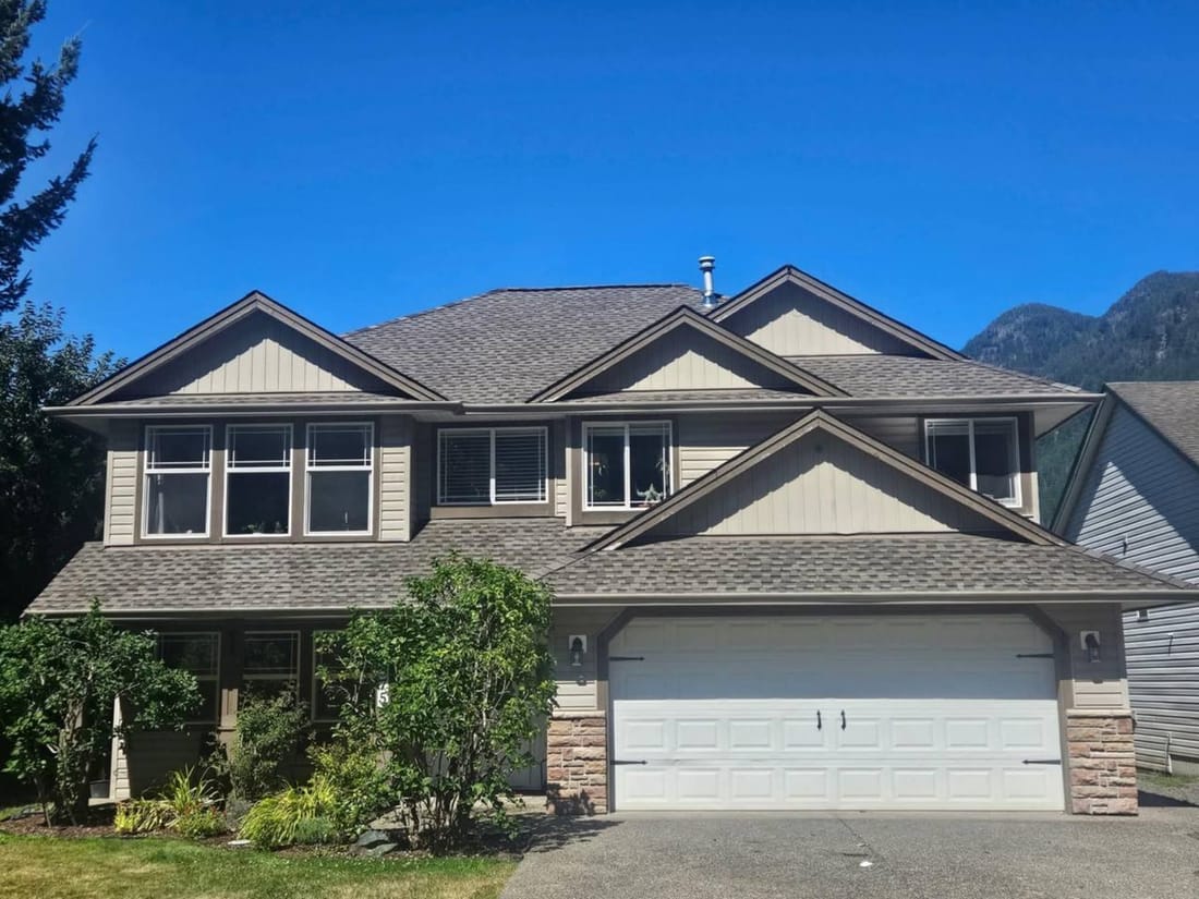 Completed asphalt shingle re-roof on a two-story home in Chilliwack BC by Fraser Roofing, a finished investment that financing options make accessible for Fraser Valley homeowners