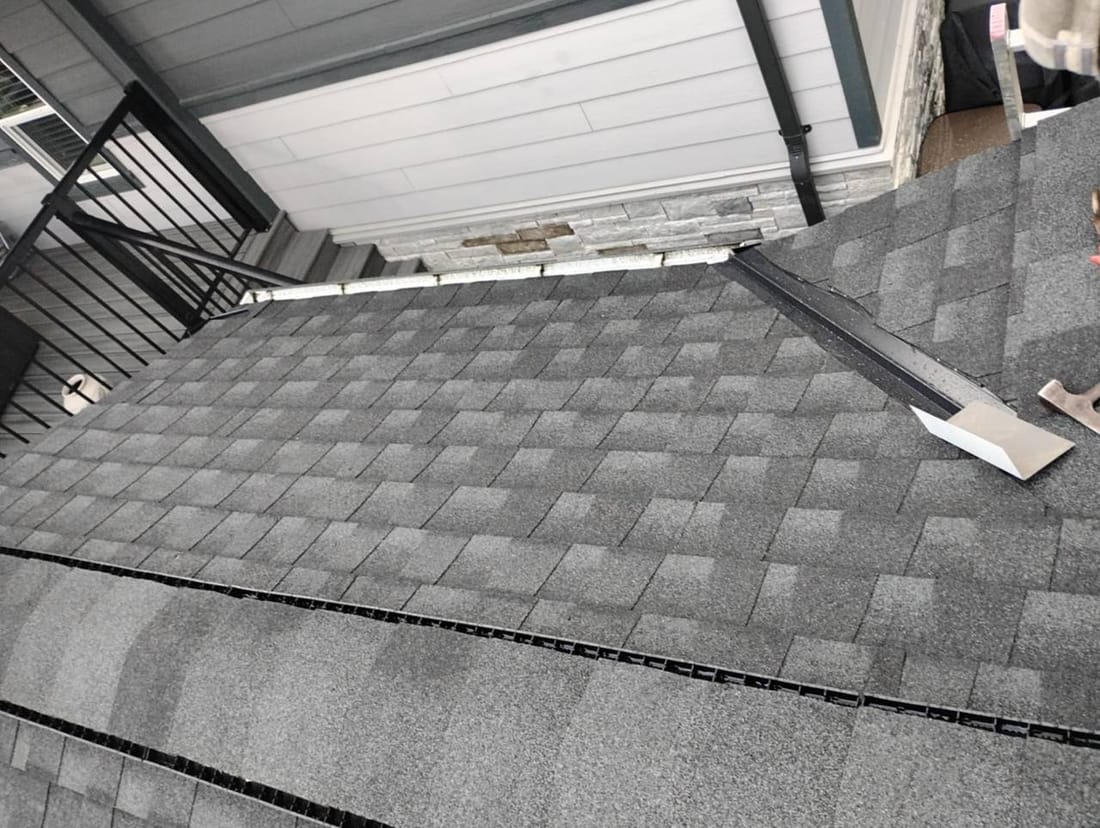Completed roof section showing ridge vent and valley on a shingled residential roof in Chilliwack BC by Fraser Roofing