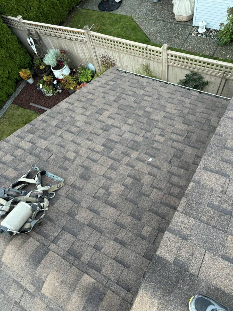 Completed section of a shingled residential roof near Harrison Hot Springs by Fraser Roofing showing clean ridge cap and valley work