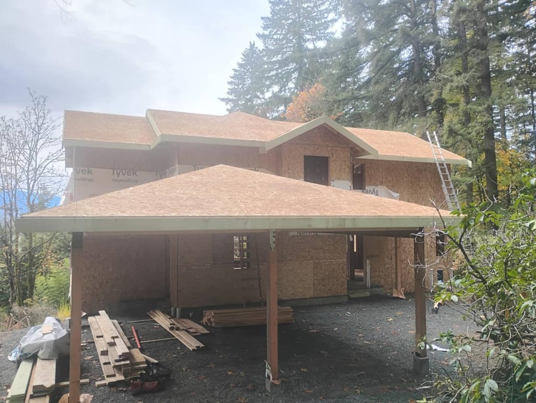 New construction roof in the Fraser Valley ready for papering and shingling, showing clean decking and staged materials by Fraser Roofing