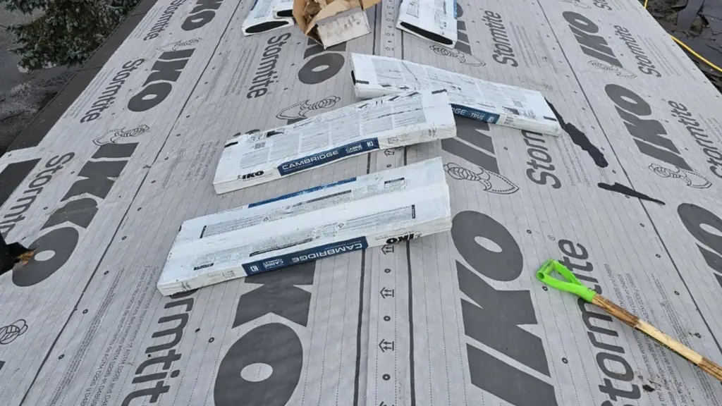 A long straight roof run fully covered in IKO Stormtite synthetic underlayment, seen from one end. Fraser Roofing
