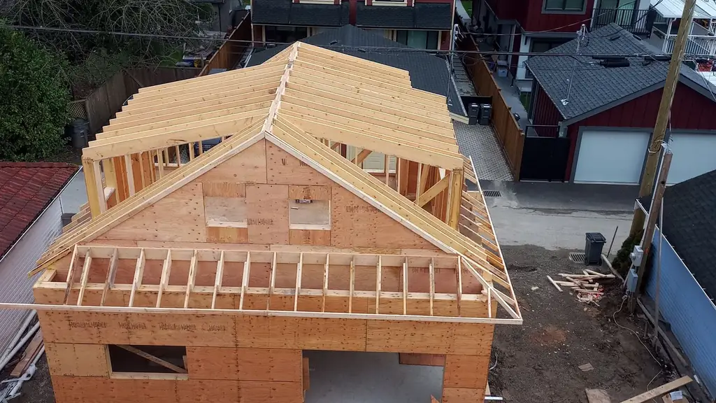 Aerial view from a newly-decked plywood roof over a house under construction. Fraser Roofing