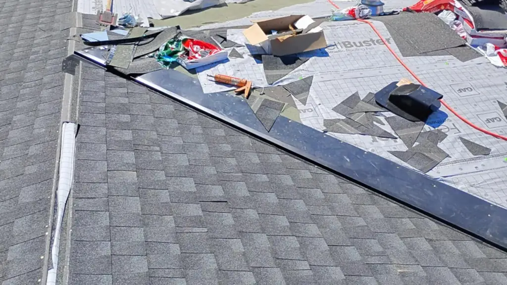 A roof mid-reshingle shows GAF FeltBuster synthetic underlayment exposed where old shingles have been removed. Fraser Roofing