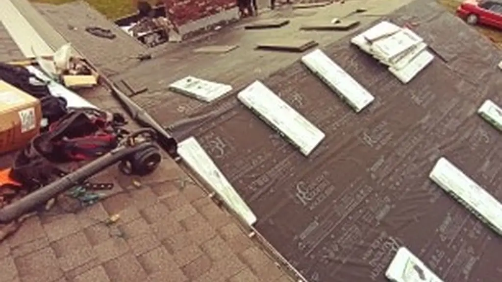 An elevated view shows a roof mid-tear-off, with old shingles stripped away to expose the deck in sections while new GAF-branded synthetic. Fraser Roofing