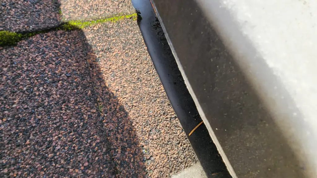Extreme close-up looking straight down at a large rounded off-white dome-shaped roof fixture, most likely a plastic vent or gutter cover. Fraser Roofing