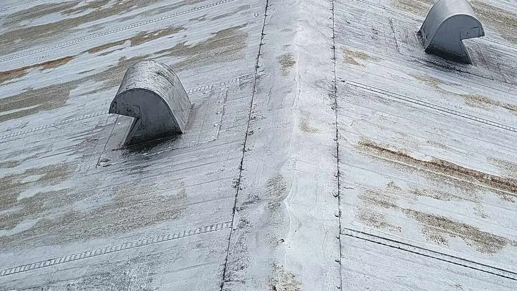 A worn, painted-over metal roof on a building in what appears to be a trailer park near Cultus Lake. Fraser Roofing
