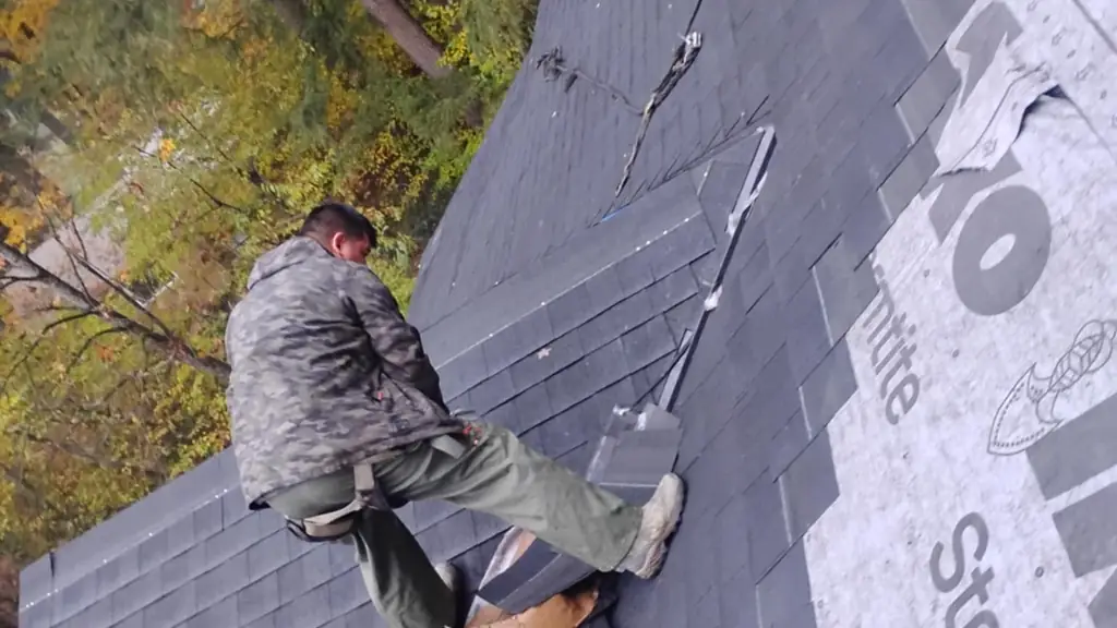 Looking down a steep asphalt shingle roof mid-installation from above. Fraser Roofing