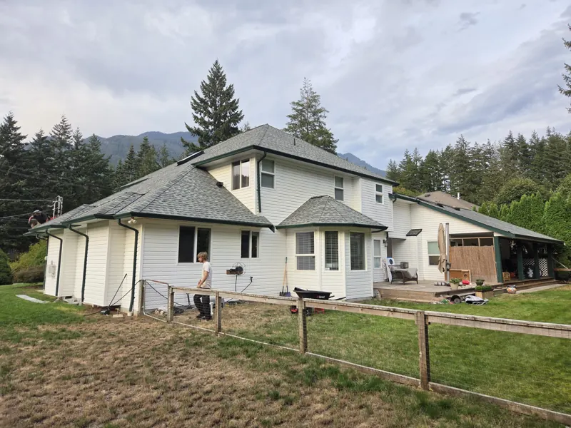 Finished roof on a whole house, mountains behind