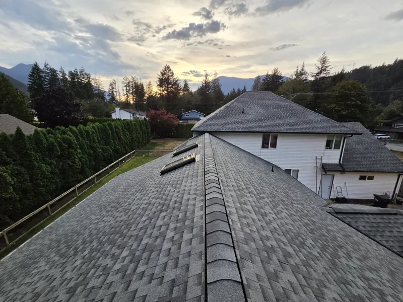 Finished grey shingle roof with skylights at sunset, Fraser Valley